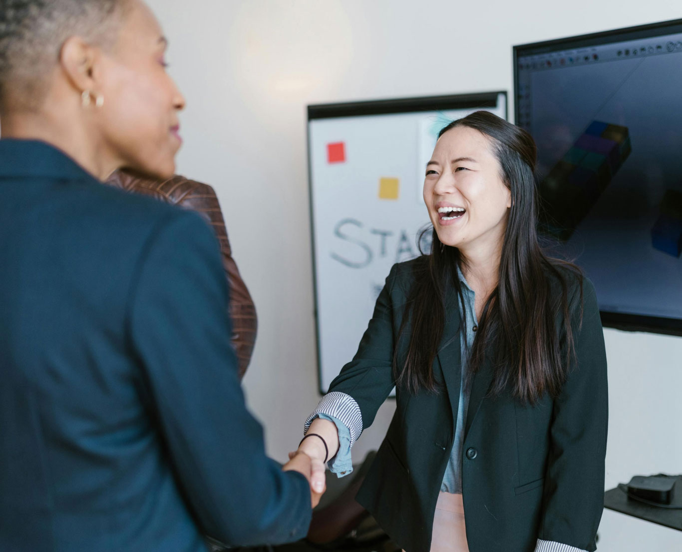 Colleagues greeting each other in an office